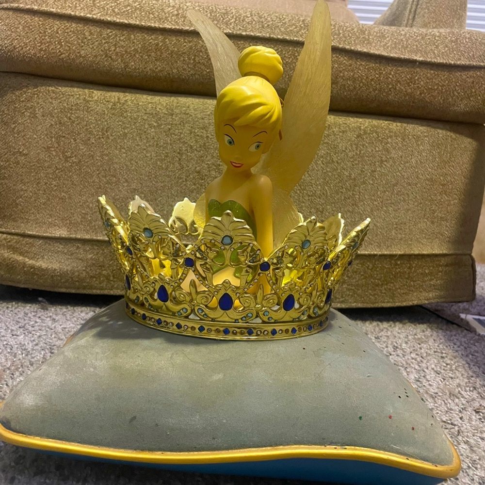 Disney antique Tinkerbelle sitting in a pillow in a crown